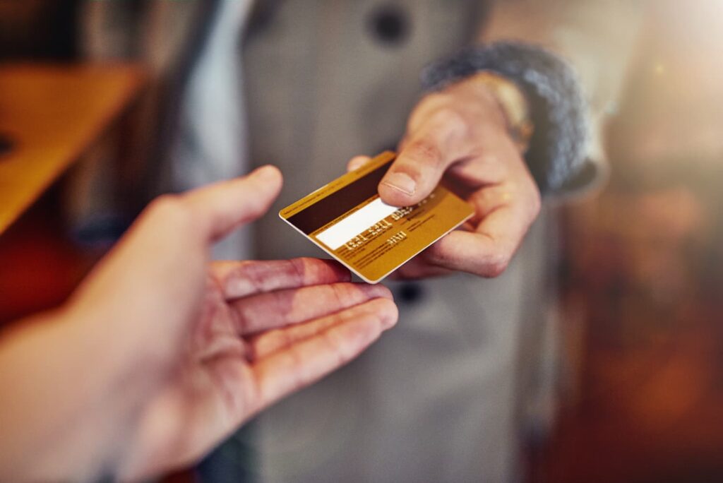 ill-put-it-on-my-card-cropped-shot-of-an-unrecognizable-young-man-handing-over-a-credit-card-in-a-shop (1)